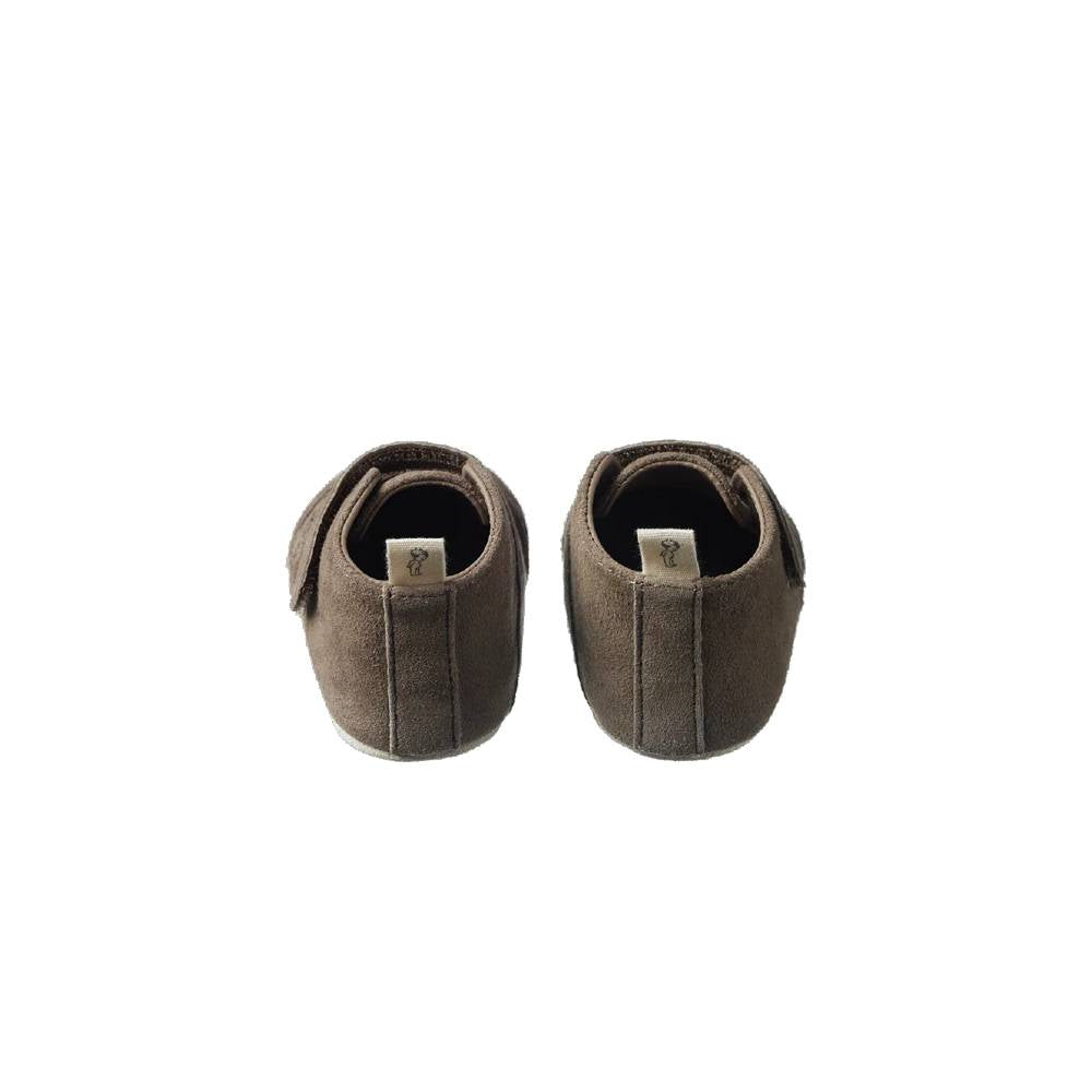 Pair of brown baby shoes on a white background