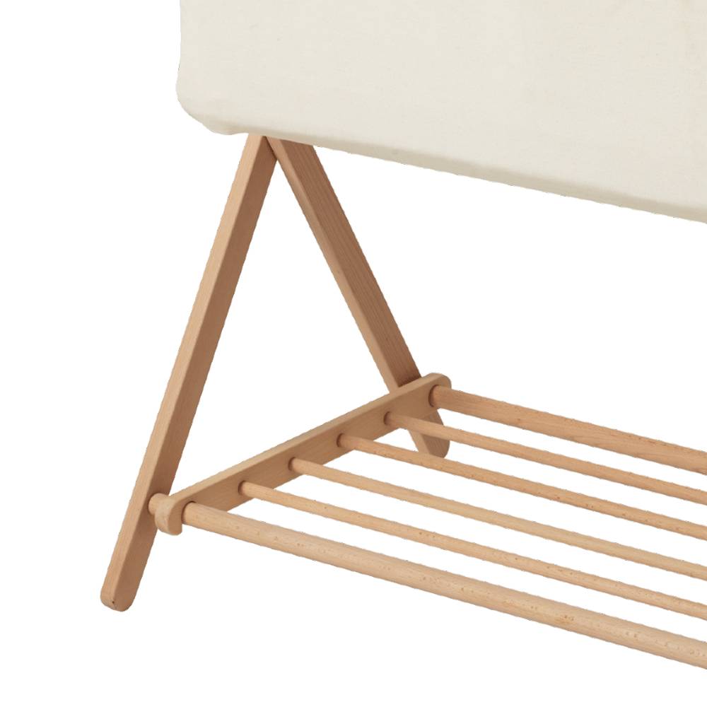Close-up of a wooden bassinet and slats with a white fabric piece on a white background
