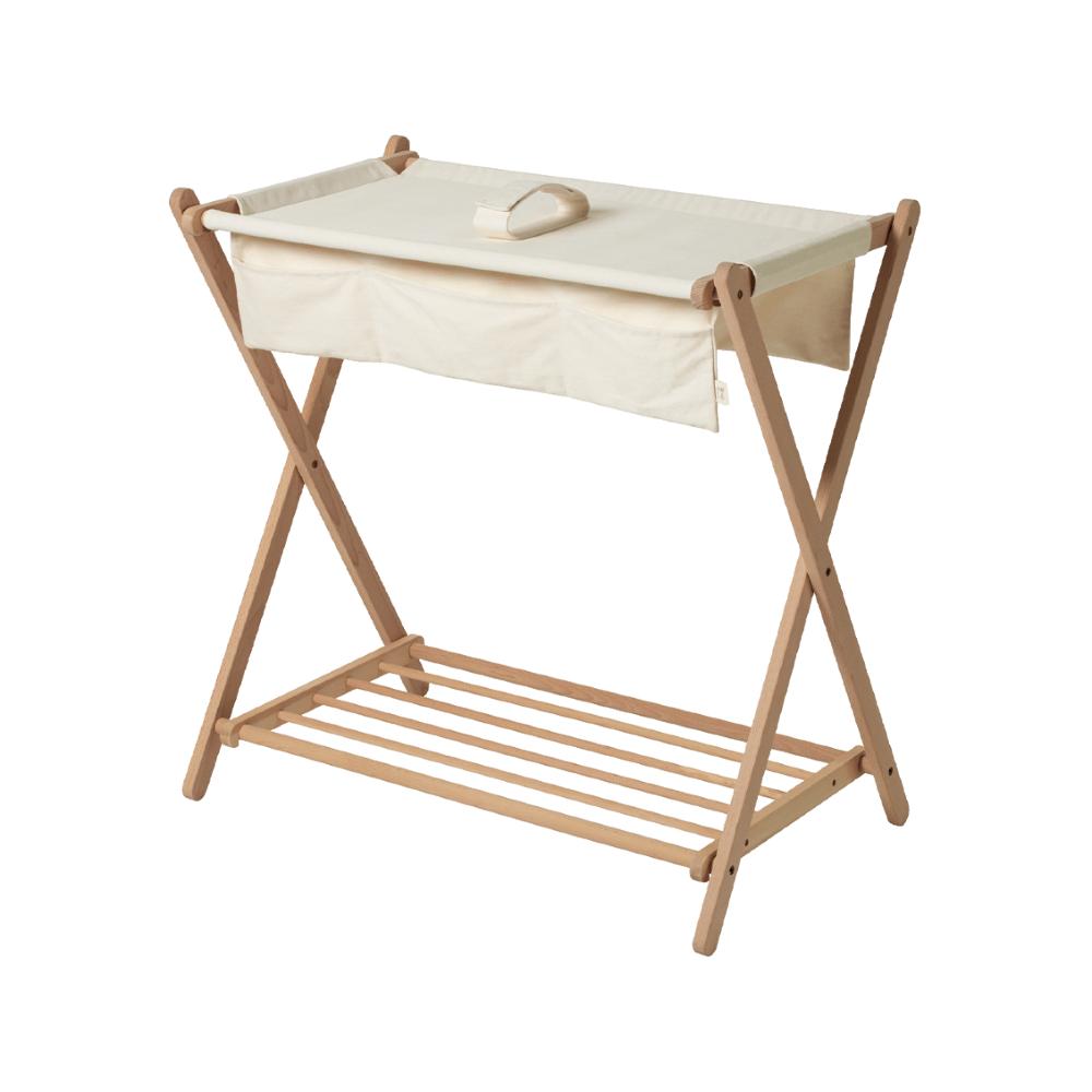 Wooden folding table with slats and a beige/cream fabric top on a white background 