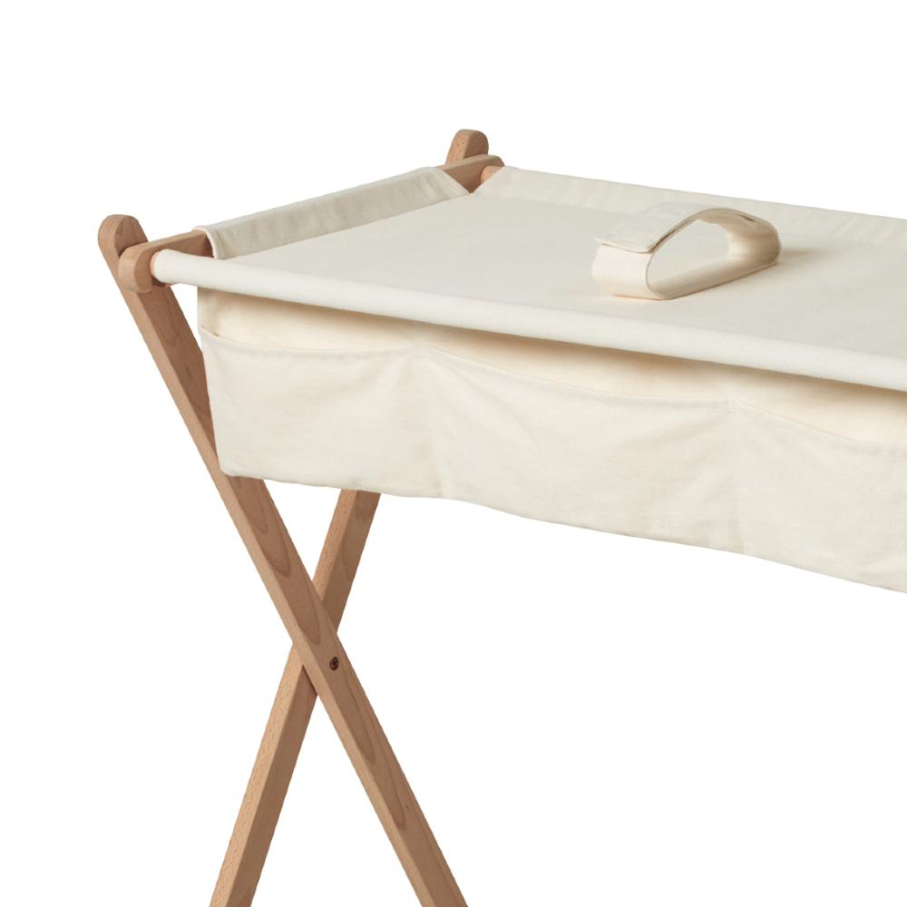 Cream-colored fabric tray with wooden frame on a white background