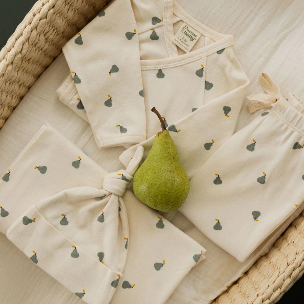 Nature Baby clothing set in a cream colour with green pear pattern on a woven basket background and a ral pear on top