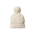 Cream knit beanie with a pom-pom and nature baby branded tag on a white background