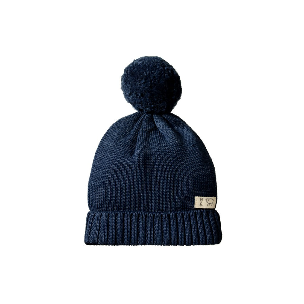 Navy Blue knit beanie with pom-pom and cuff on a white background