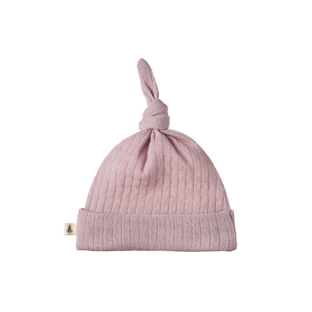 Lilac merino pointelle knit baby hat with a knot on a white background