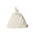 Cream merino pointelle knit baby hat with a knot on a white background