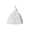 White pointelle cotton knit baby hat with a knot on top against a white background