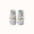 Pair of organic cotton grey striped baby booties with white calico laces on a white background