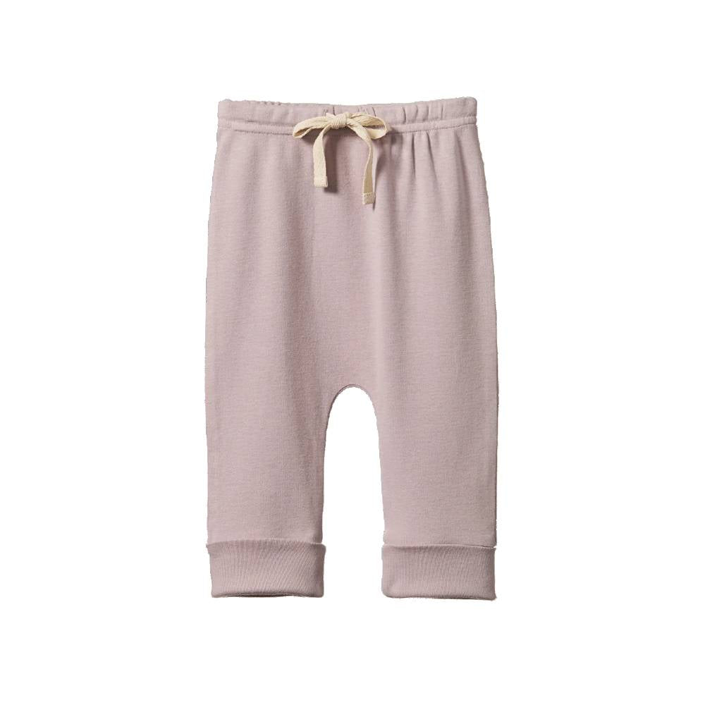 A pair of cotton drawstring pants in a dusty lilac color, featuring a cream-colored drawstring at the elastic waistband and ribbed cuffs at the ankles, shown against a plain white background.