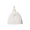 White cotton nature baby hat with a knot on top against a white background
