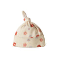 Cream cotton baby knotted beanie with a floral print on a white  background. 