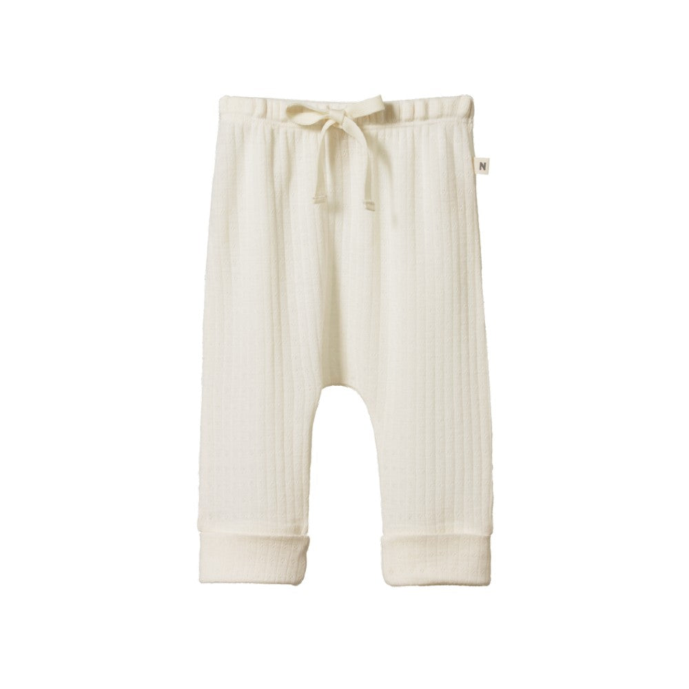 Cream merino wool pointelle baby pants with a drawstring and cuffs on a white background