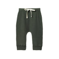 Forest green pointelle merino wool baby pants with a white drawstring on a white background
