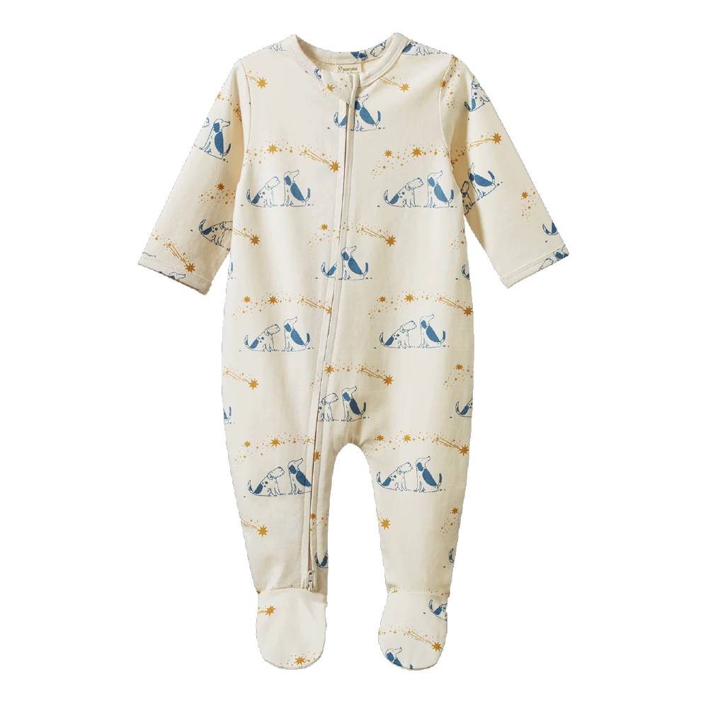 A baby footed sleep suit in cream with a blue and yellow print of dogs and stars, shown on a plain white background.