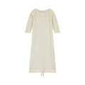 Cream coloured merino pointelle baby gown with long sleeves and drawstring at bottom on a white background