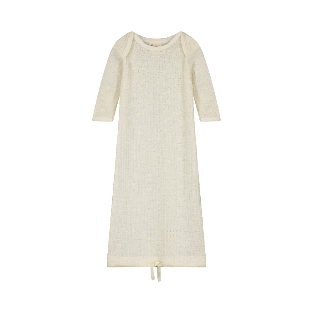 Cream coloured merino pointelle baby gown with long sleeves and drawstring at bottom on a white background