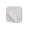 Cream coloured  organic muslin cotton baby face cloths with a small nature baby brand logo visible on a white background