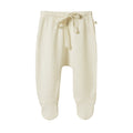 Cream baby merino pointelle footed baby pants with a drawstring on a white background