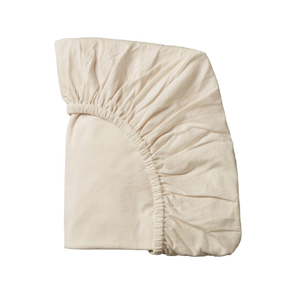 Cream organic cotton jersey fitted sheet on a white background