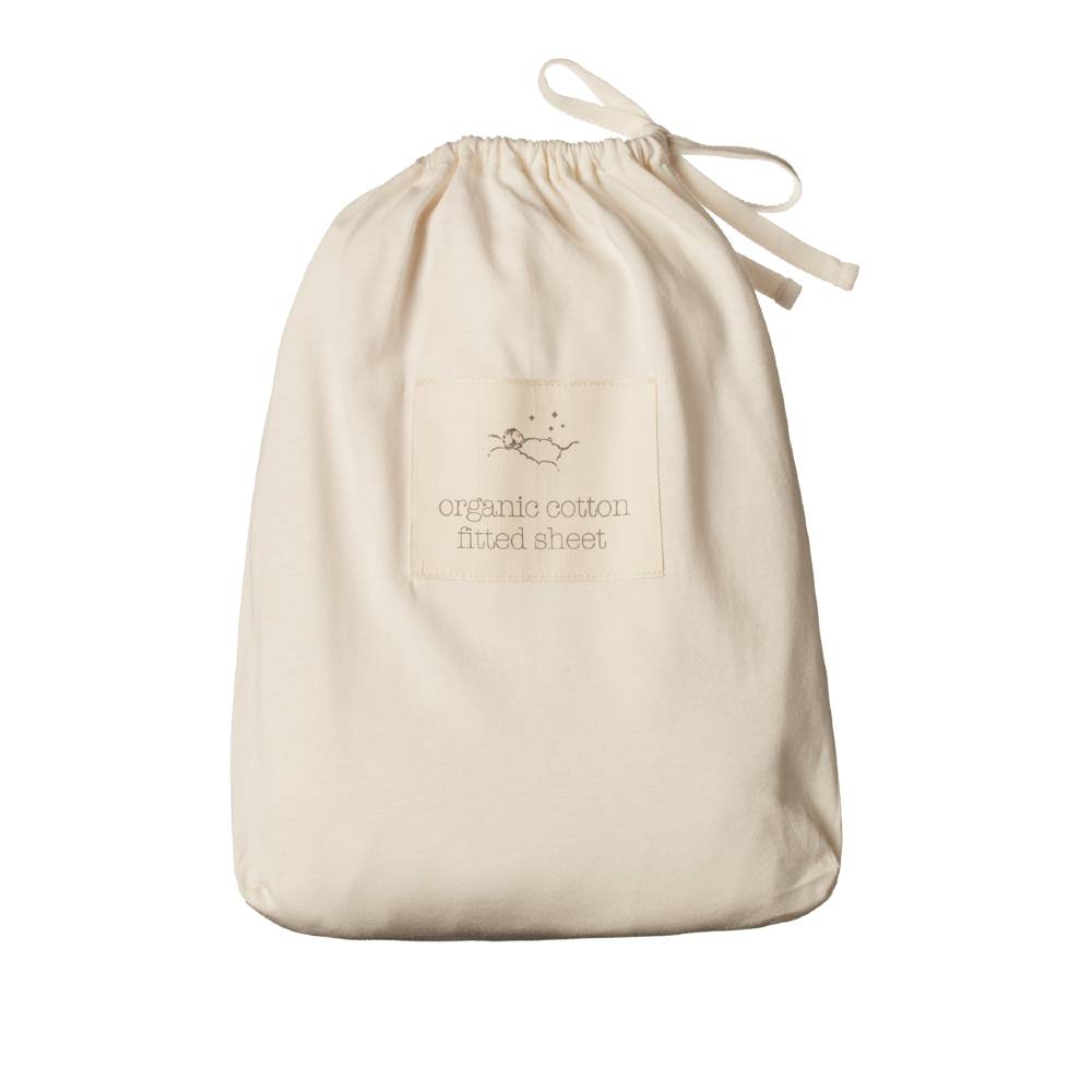 Cream drawstring bag with 'organic cotton fitted sheet' label on a white background