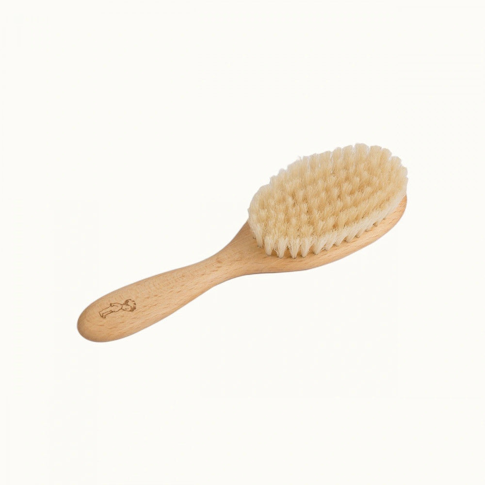 Beige wooden toddler brush with nylon bristles and small nature baby branded picture on handle on a white background