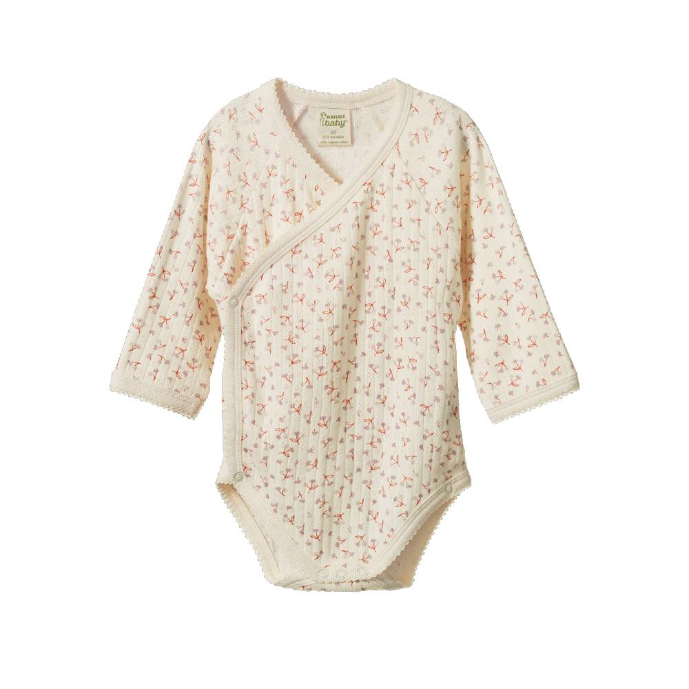 Cotton pointelle long sleeve bodysuit with a floral pattern on a white background. 