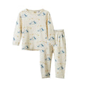 A two-piece pajama set featuring a long-sleeve top and matching pants in cream with a blue dog pattern, displayed on a clean white background.
