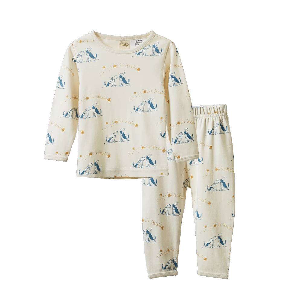 A two-piece pajama set featuring a long-sleeve top and matching pants in cream with a blue dog pattern, displayed on a clean white background.