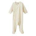 Cream-colored merino pointelle baby kimono stretch and grow on a white background