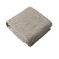 Woolen knitted grey textured blanket on a white background