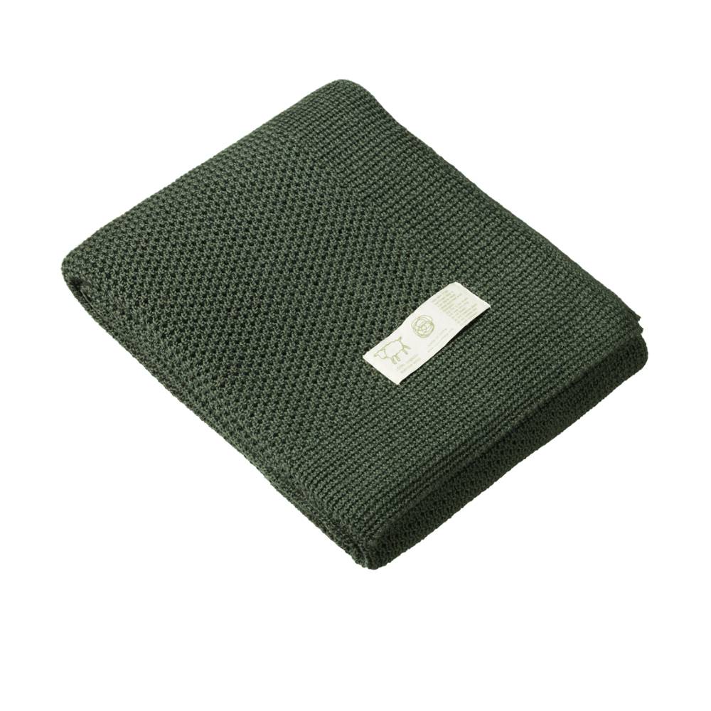 Forest Green merino wool knitted blanket with a white label on a white background