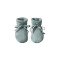 Pair of sage merino knitted baby booties on a white background