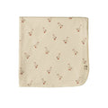 A square cream-colored baby swaddle wrap with a repeating pattern of small brown and red geese, featuring a small brand tag on the bottom right corner.