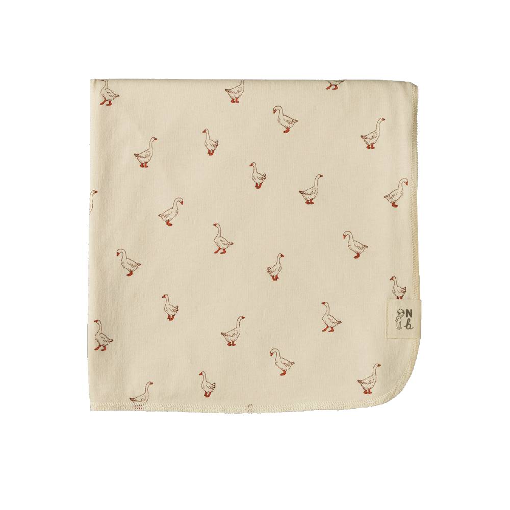 A square cream-colored baby swaddle wrap with a repeating pattern of small brown and red geese, featuring a small brand tag on the bottom right corner.