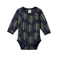 Navy cotton baby bodysuit with long sleeves and envelope neck and abstract tree pattern on a white background