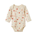 A long-sleeve cream-colored baby bodysuit with a delicate floral pattern in red, orange, and blue, featuring scalloped edges and snap closures.