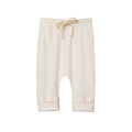 Cream pointelle cream baby pants with a drawstring and cuffs on a white background