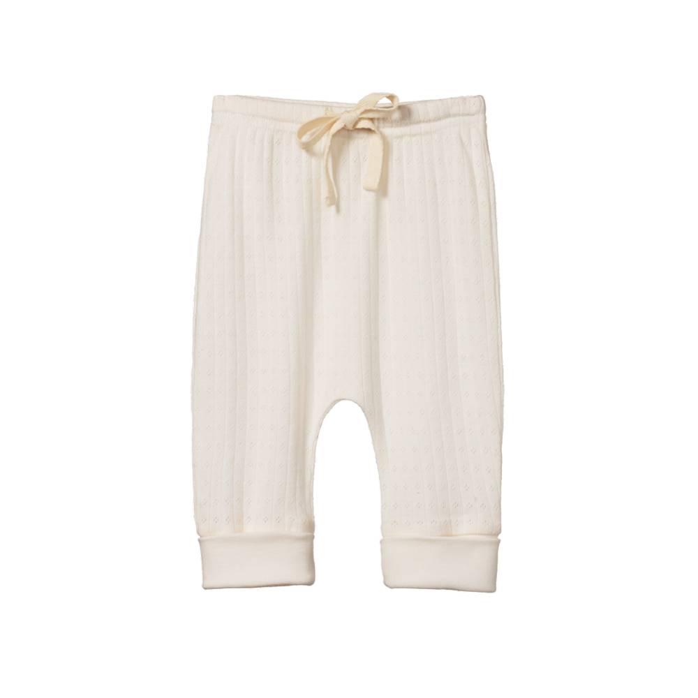 Cream pointelle cream baby pants with a drawstring and cuffs on a white background