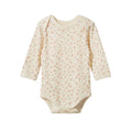A long-sleeve baby bodysuit in cream-colored ribbed fabric with a small, all-over floral pattern shown against a plain white background.