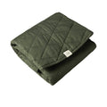 Forest green quilted play mat with a nature baby brand label on a white background