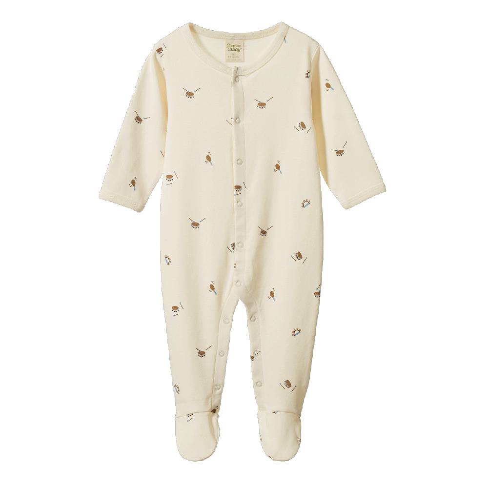 A cream-colored baby footed onesie with a small brown drums print, featuring a snap-button front and long sleeves, shown against a plain white background.