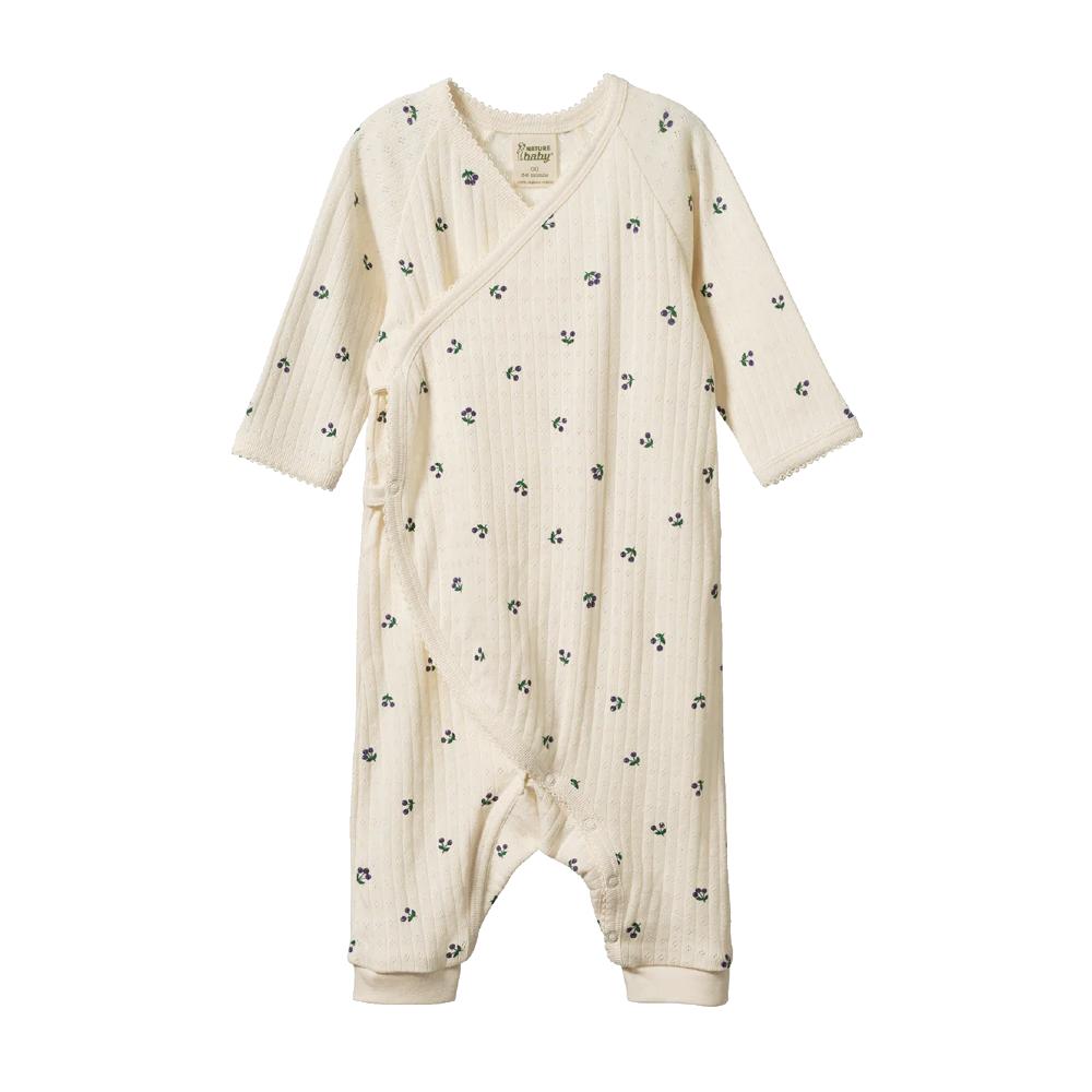 Cotton pointelle baby onesie without feet and a purple winter berry pattern on a white background