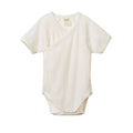 White cotton pointelle baby short sleeve bodysuit in a kimono style on a white background