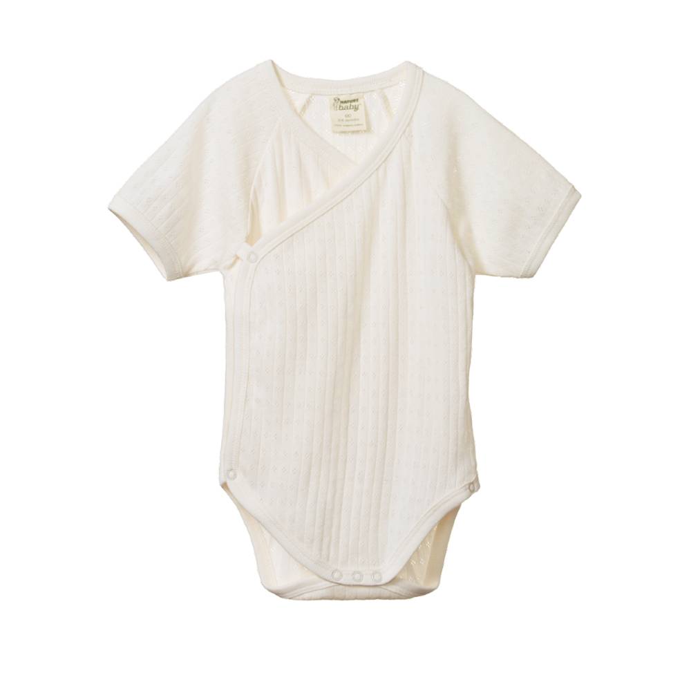 White cotton pointelle baby short sleeve bodysuit in a kimono style on a white background