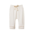 Cream coloured nature baby cotton baby pants with a drawstring on a white background