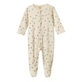 Cream Baby footed onesie with snap buttons with a pink and green clover pattern on a white background