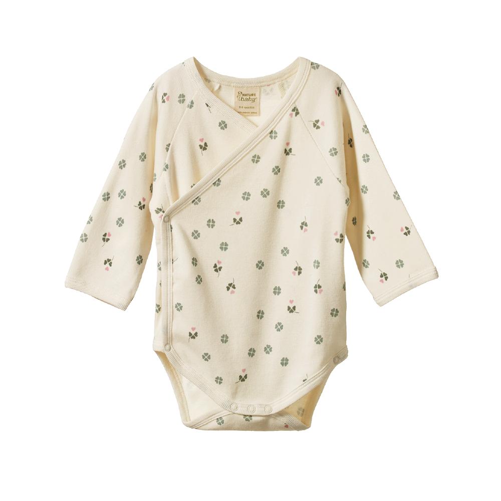Cream kimono style organic cotton bodysuit with green and pink clover  pattern on a white background