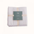 Packaged white baby nappy squares with a green Nature Baby label on a white background