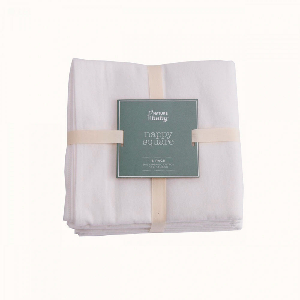 Packaged white baby nappy squares with a green Nature Baby label on a white background