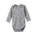 Grey merino baby bodysuit with long sleeves and envelope neck with blue dog line pattern on a white background