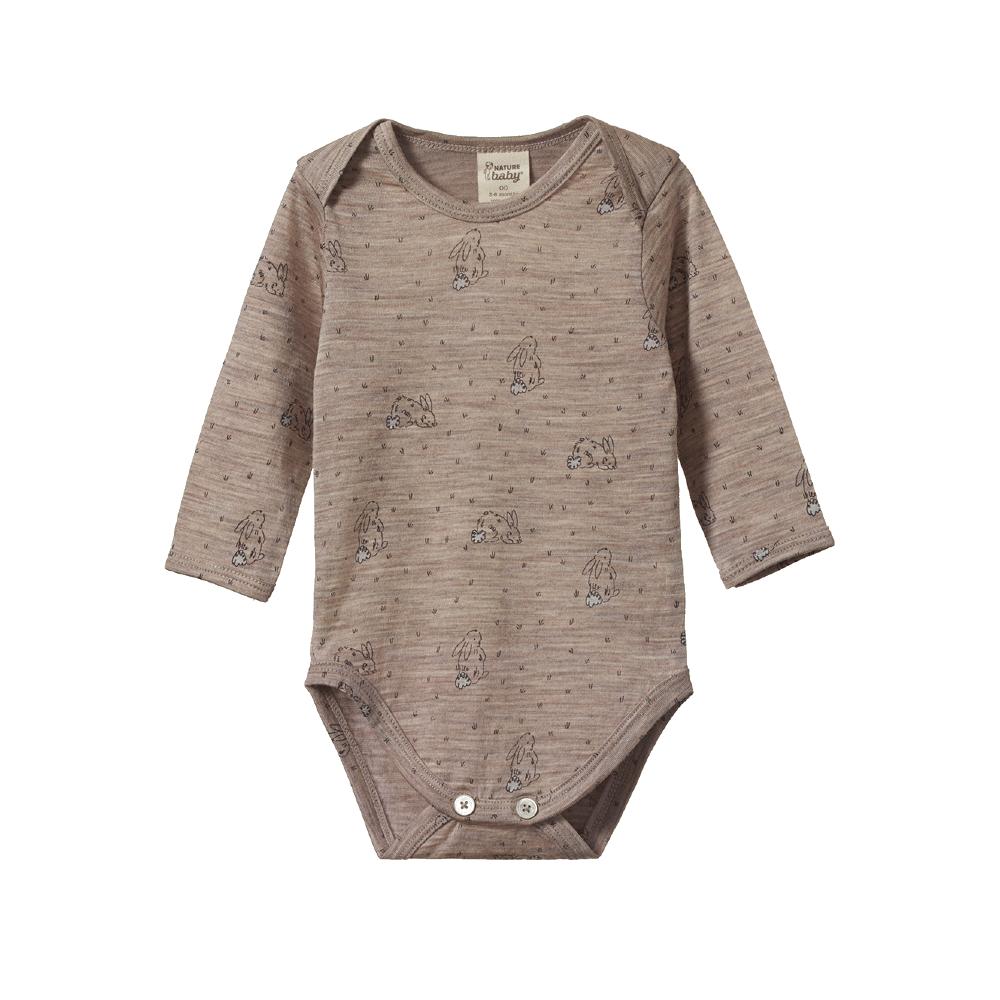 Brown merino baby bodysuit with long sleeves and envelope neck with soft bunny design pattern on a white background